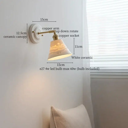 Vintage ceramic wall sconce with white bell-shaped shade and copper arm featuring bedroom pull chain lamp design