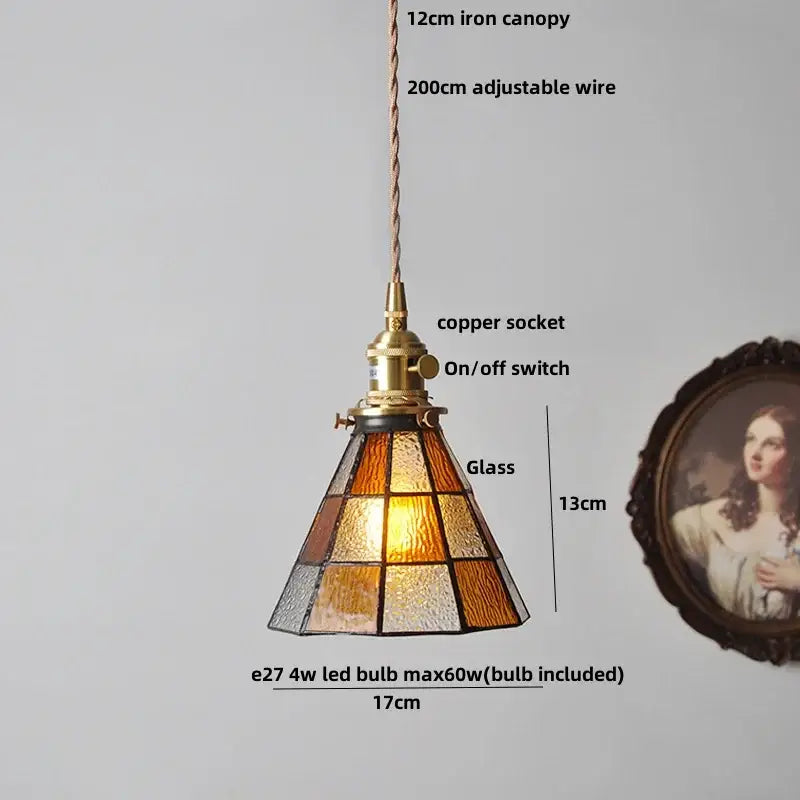 A warm-toned colorful glass tiffany pendant lamp with brass-finished copper socket and adjustable wire suspension