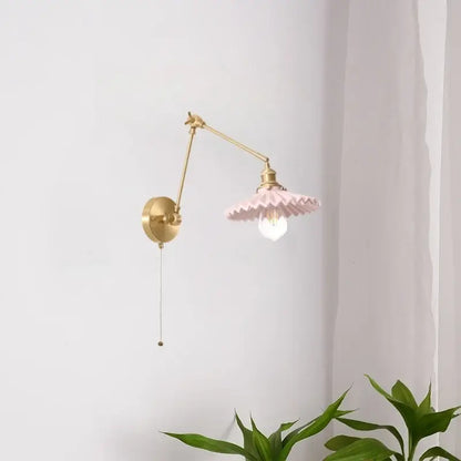 Vintage copper wall sconce with a delicate pink ceramic ruffled lampshade and adjustable brass arm with pull chain decorbites copper vintage