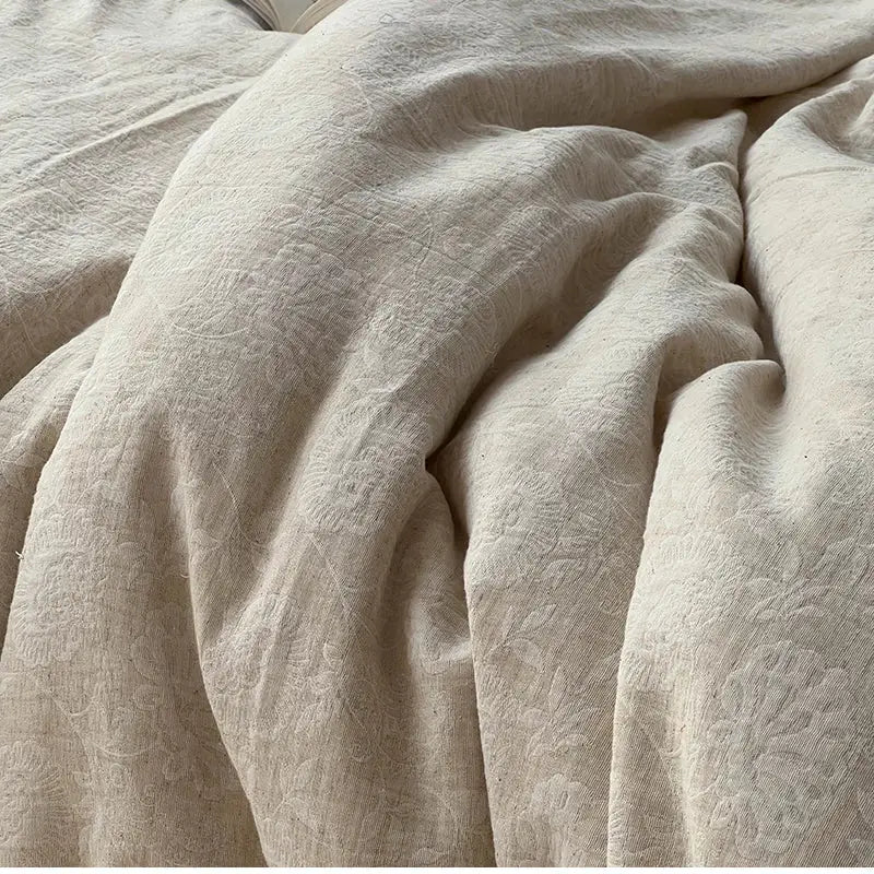 Beige linen duvet cover with subtle floral embroidery in vintage cream bedding set with jacquard lace ruffles