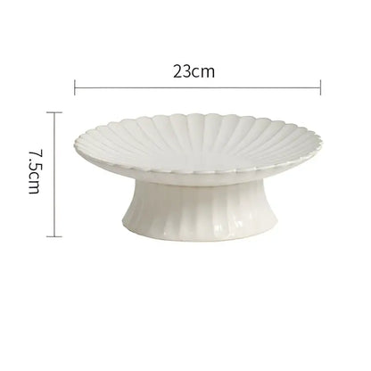 White ceramic cake stand with fluted scalloped edge and pedestal base in vintage cream dining table set