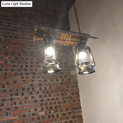 Two vintage dark brown metal island light pendant lights with brass frames emit warm led incandescent light