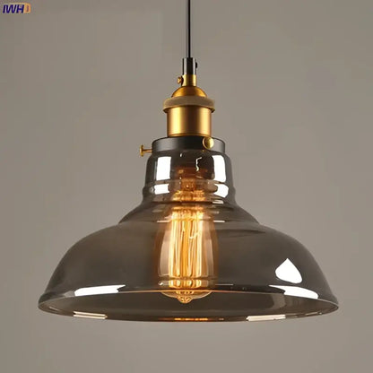 Vintage dark glass pendant lights set of 4 with smoked glass shades and brass accents featuring exposed Edison bulbs