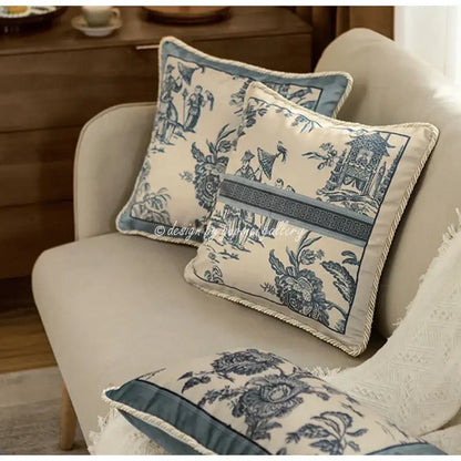 Cream-colored vintage delft blue toile cushion covers with intricate patterns and fringed rope trim decorbites delft blue