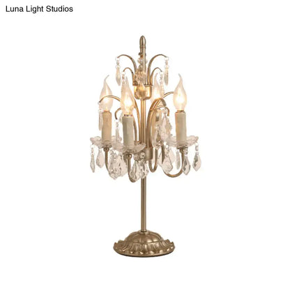 DecorBites vintage metallic nightstand lamp with antique brass finish, five candle bulbs, and hanging crystal droplets
