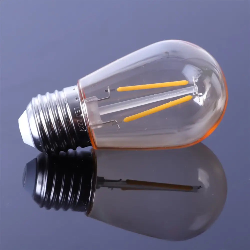 Clear glass edison-style led bulb with yellow filament and black base from vintage decorbites amber plastic bulbs 6-pack