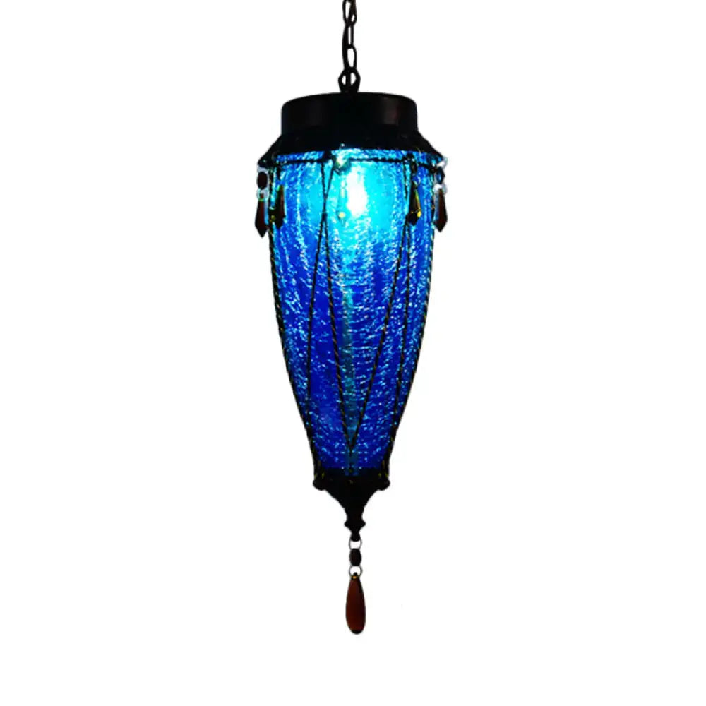 Vibrant blue glass pendant light with black metal accents and amber teardrop charm for vintage restaurant lighting