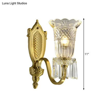 Gold-finished vintage floral wall light with ornate design, faceted crystal glass shade, and dangling crystal accents