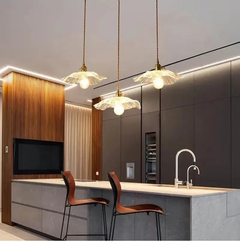 Three elegant multi color vintage flower glass pendant lights with translucent petal shades and brass fixtures for dining room