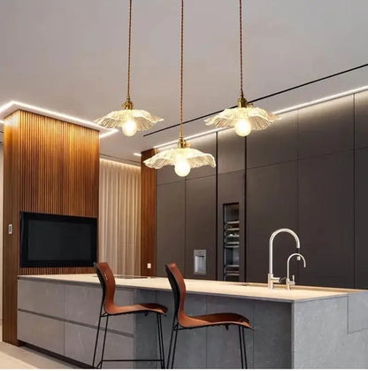 Three elegant multi color vintage flower glass pendant lights with translucent petal shades and brass fixtures for dining room