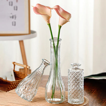 Vintage French clear glass vase with vertical ridges holding pale pink calla lilies for elegant plant pot decor