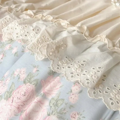 Vintage french floral bedding set with cream lace ruffle and intricate eyelet embroidery over blue floral fabric