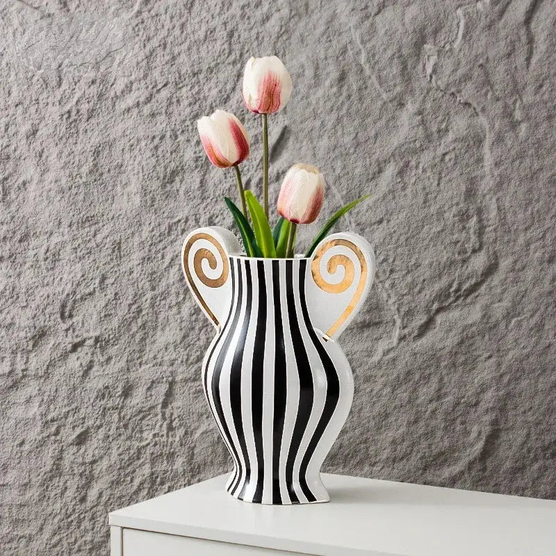 A sleek black and white ceramic vase with geometric fringe design and gold spiral handles for living room decorbites decor