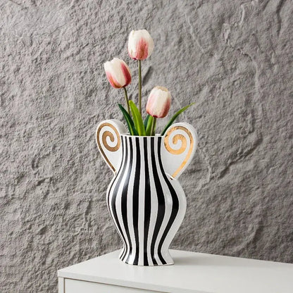 A sleek black and white ceramic vase with geometric fringe design and gold spiral handles for living room decorbites decor