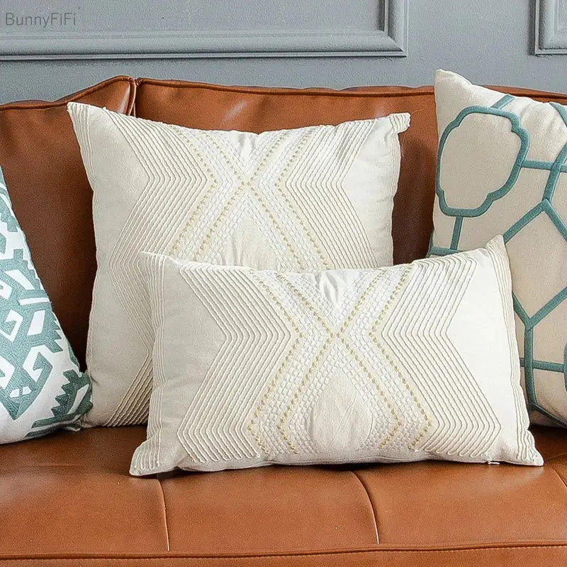 Cream-colored cushion cover with stitched x-shape pattern featuring decorbites geometric ivory vintage gold embroidery