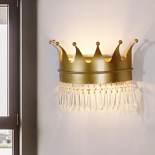 Vintage gold crown wall lamp with clear crystal tassels designed as a bedroom sconce for elegant lighting