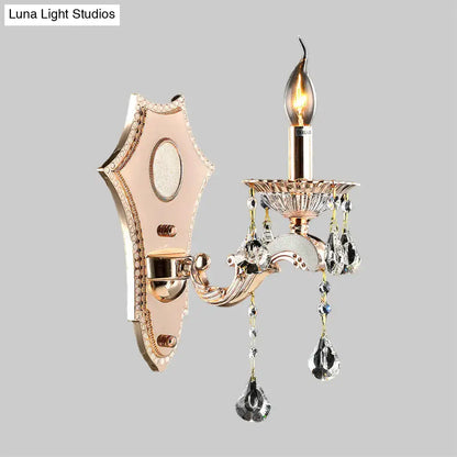 Elegant rose gold direct wired electric sconce light fixture with crystal teardrop pendants and candle-style bulb for bedroom wall mount