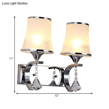 Chrome-finished wall lamp with two frosted beige clear glass shades and dangling crystal teardrop pendants