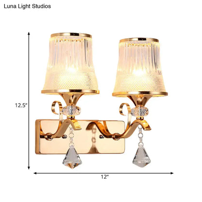 Vintage gold finish wall lamp featuring clear glass fluted shades and crystal teardrop pendants for bedroom use