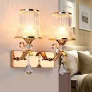 Vintage gold finish wall lamp with clear glass ribbed shades and crystal pendants for elegant bedroom lighting