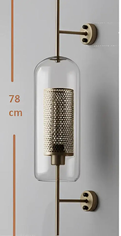 A vintage gold mesh led wall sconce with a brass finish and clear glass cylinder for bedroom decorbites led wall lighting