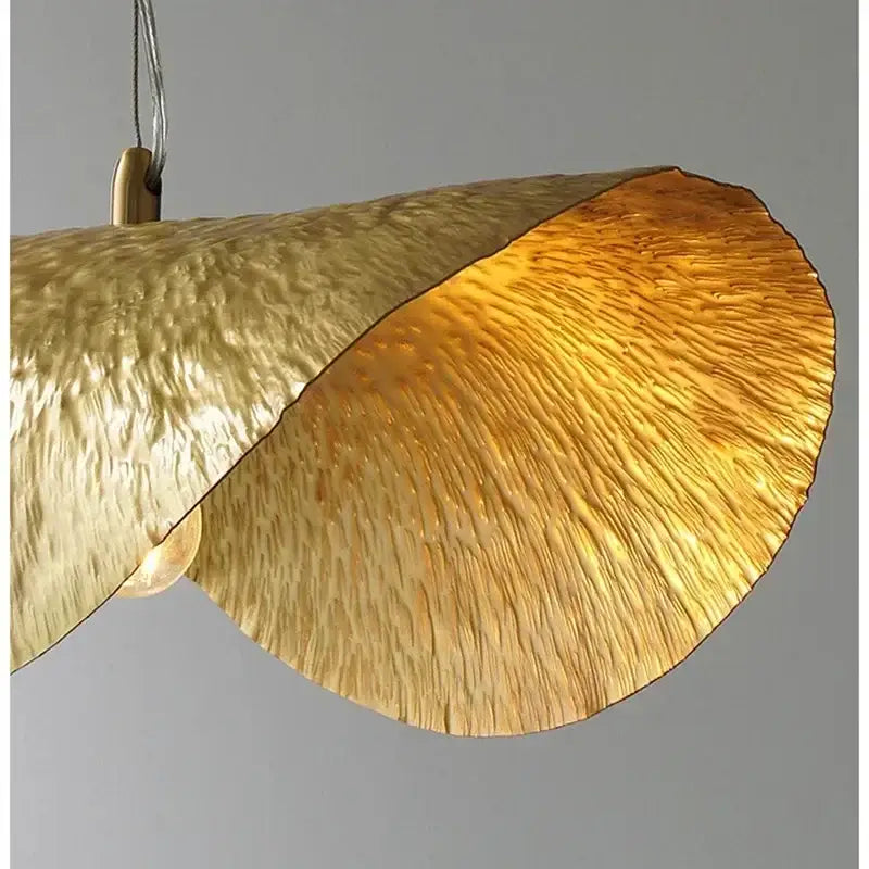 Vintage gold metal pendant light with hammered textured leaf design ideal for dining room lighting