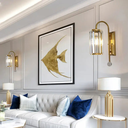 Vintage gold wall light with clear crystal shade featuring gold-leafed angelfish artwork in sleek black frame