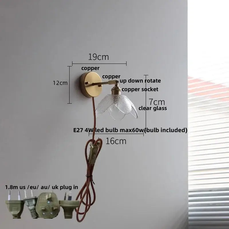 Vintage brass wall sconce with copper adjustable arm and clear glass flower-shaped shade for bedroom stair light
