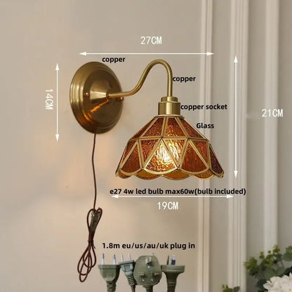 Antique brass wall sconce with stained glass shade in amber and gold tones for vintage green glass led stair lighting