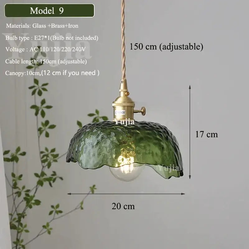 Green glass pendant light with textured ruffled petal design and brass hardware for dining room use