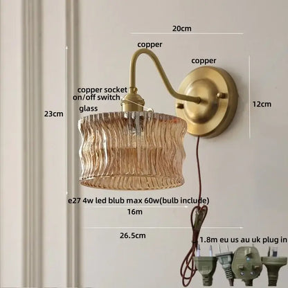 Vintage wall light with copper knob switch featuring antique brass copper and textured amber glass shade