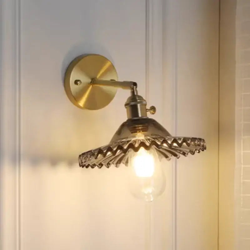 Vintage green glass wall light with brass finish scalloped shade and pull chain switch for bedroom use