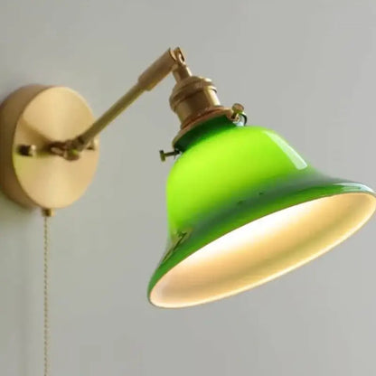 Vibrant green glass bell-shaped lampshade mounted on brass arm in vintage green loft led wall lamp with pull chain
