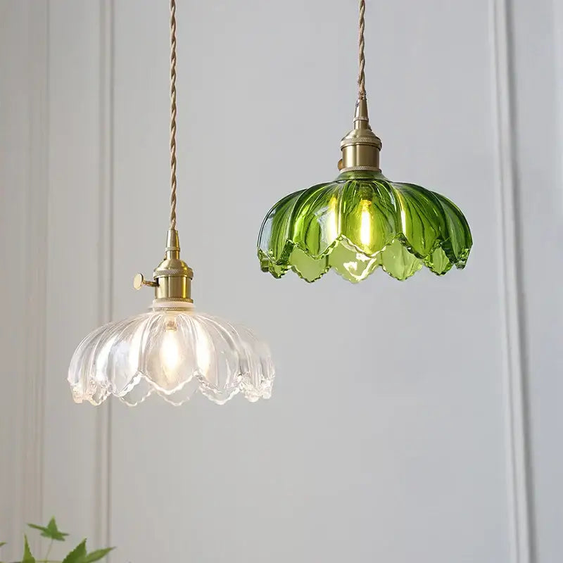 Vintage green and white glass flower pendant lights with brass fixtures and twisted cords, thoughtfully styled for dining rooms