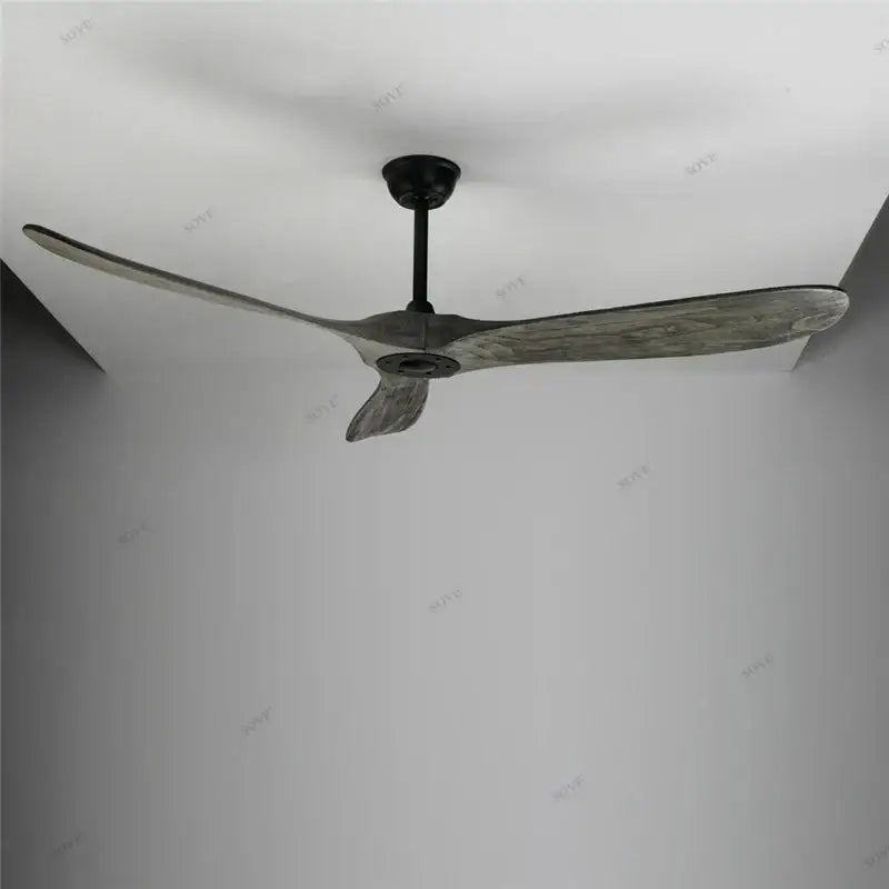 Modern vintage ceiling fan with three slender weathered grey wood blades and matte black hub for living room use