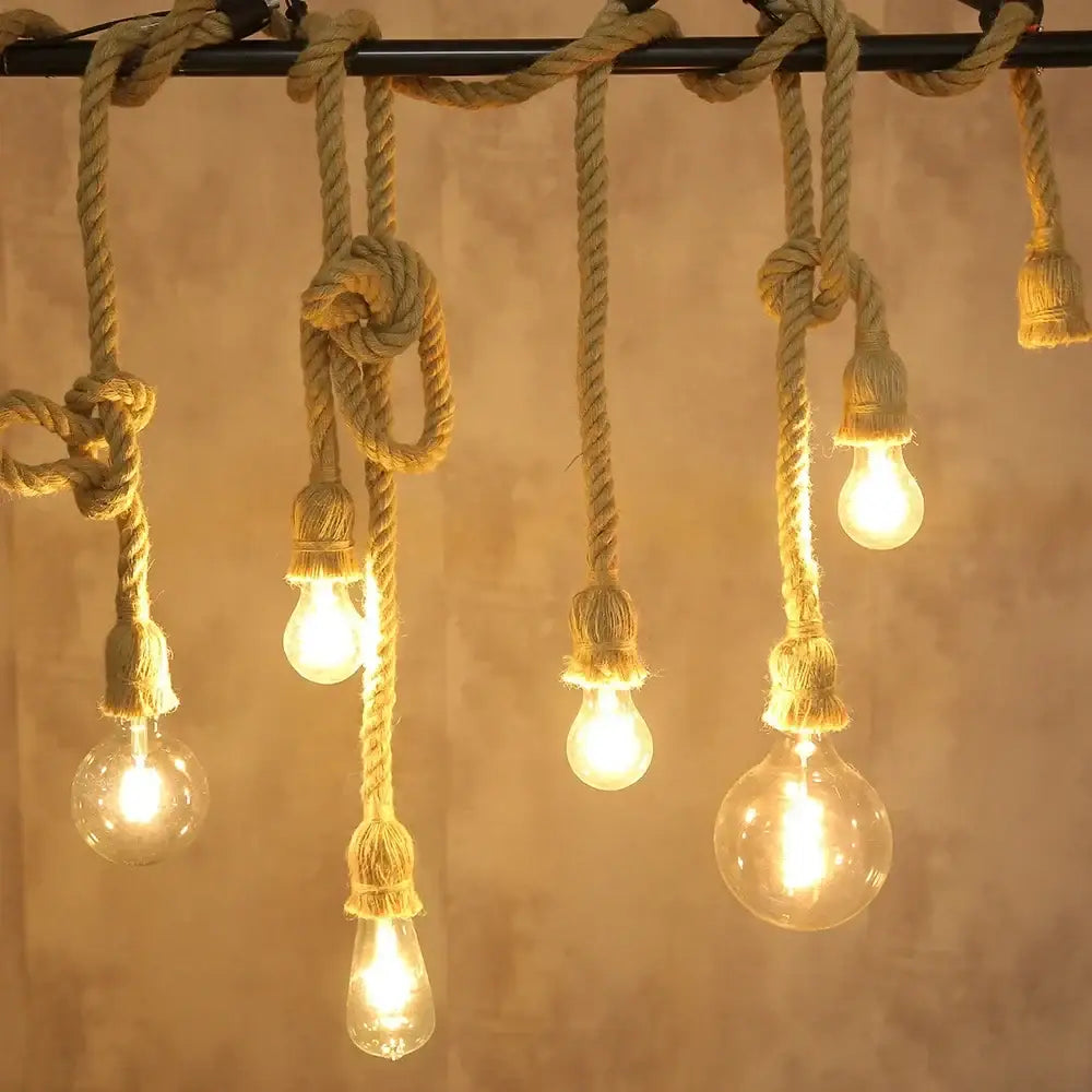 Rustic vintage hemp rope pendant light with warm glowing glass bulbs and thick natural twine for focused lighting