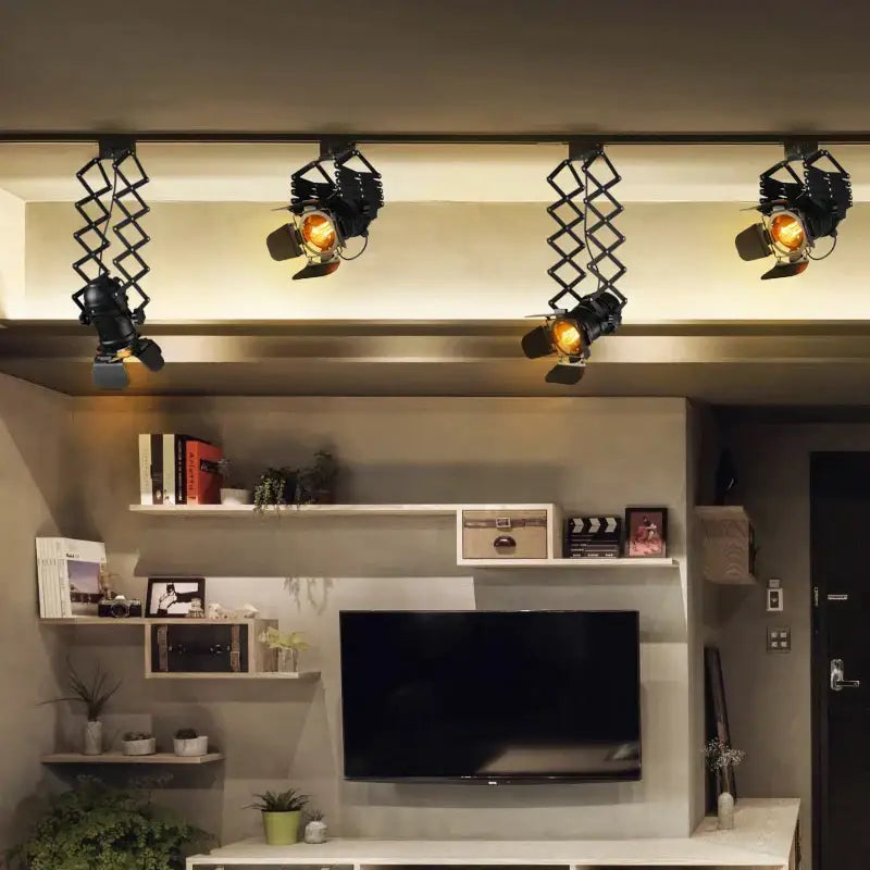 Four black vintage style decorbites adjustable loft ceiling light spotlights with articulated arms above a tv