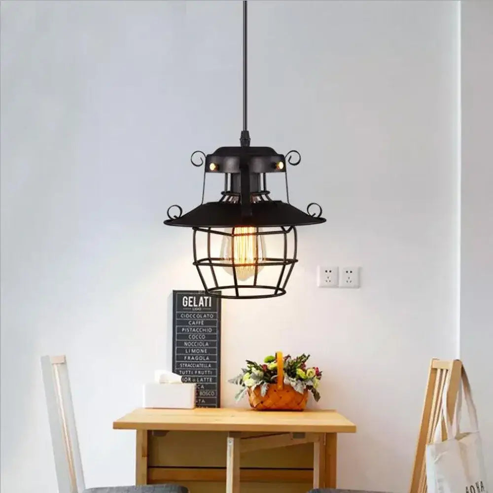 Black wrought iron pendant light with cage design and exposed filament bulb metal construction cord pendant