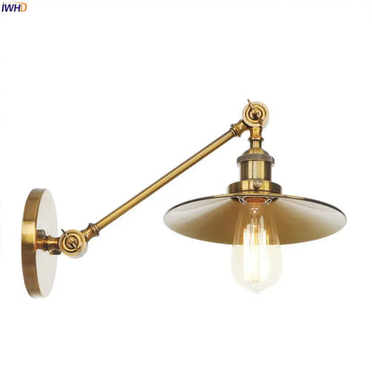 Brass-finished vintage industrial wall lamp with gold swing arm and bell jar shade featuring exposed edison bulb