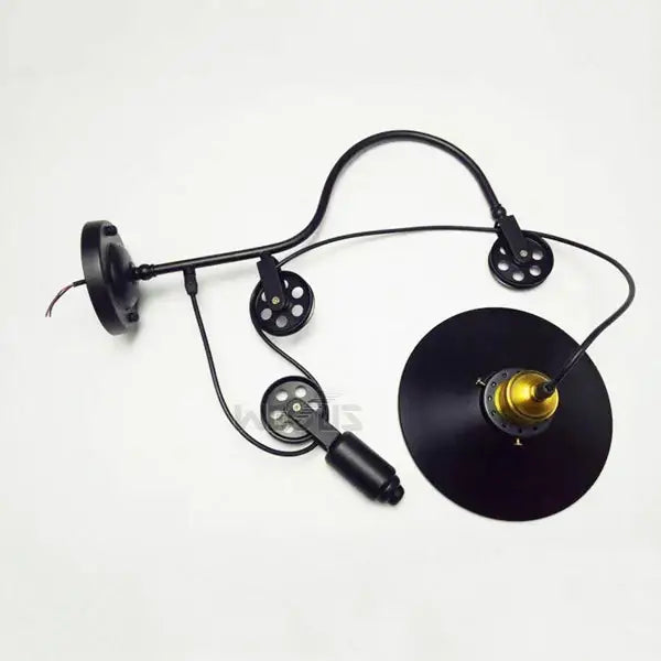 Black industrial-style iron pulley wall lamp with three adjustable arms and gold-toned sockets for dining room decorbites iron pulley
