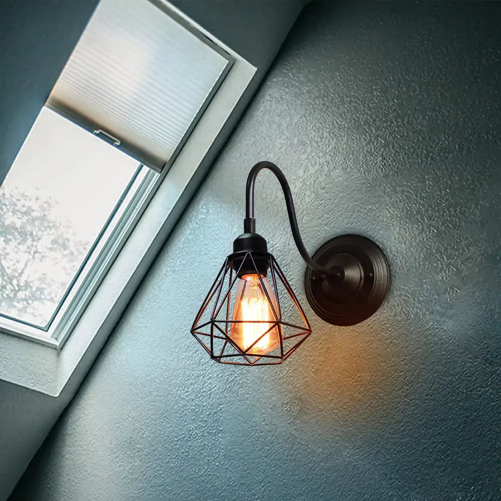 Vintage industrial cage wall lamp with black metal frame and exposed Edison bulb for decorbites industrial cage sconce