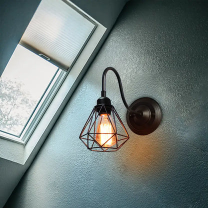 Vintage industrial cage wall lamp with black metal frame and exposed Edison bulb for decorbites industrial cage sconce