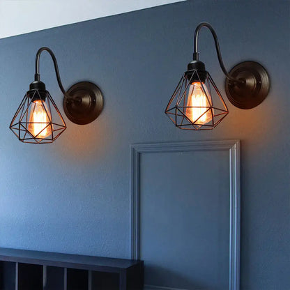 Vintage industrial cage wall lamp black metal sconce with geometric wire cages and glowing edison bulbs by decorbites industrial cage