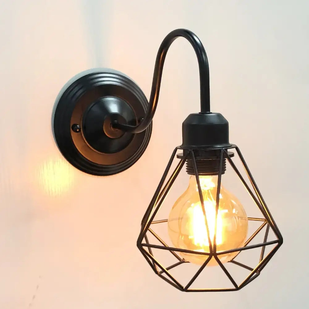 Black wrought iron industrial cage wall lamp with geometric wire cage and exposed filament bulb for decorbites industrial cage decor