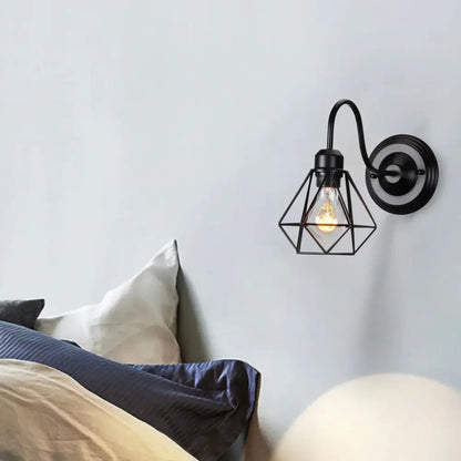 Black wrought iron wall lamp with geometric industrial cage housing exposed filament bulb for decorbites industrial cage wall lighting