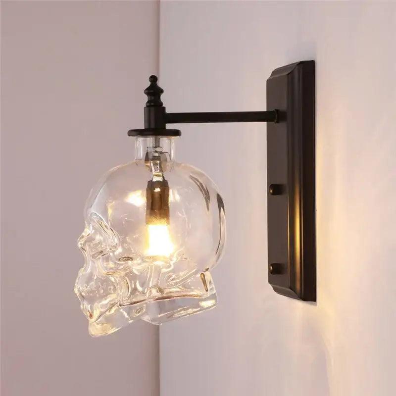 Clear glass skull wall sconce with black metal bracket and arm vintage industrial living room lamp