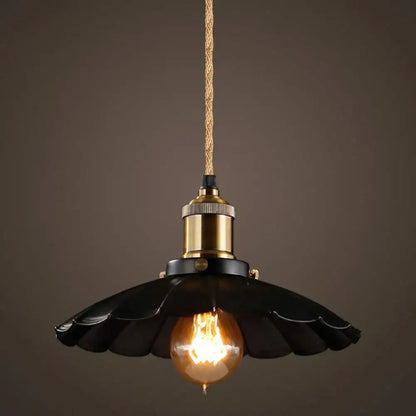 Black scalloped metal pendant light with brass socket and exposed filament bulb featuring woven textile wire and hemp rope