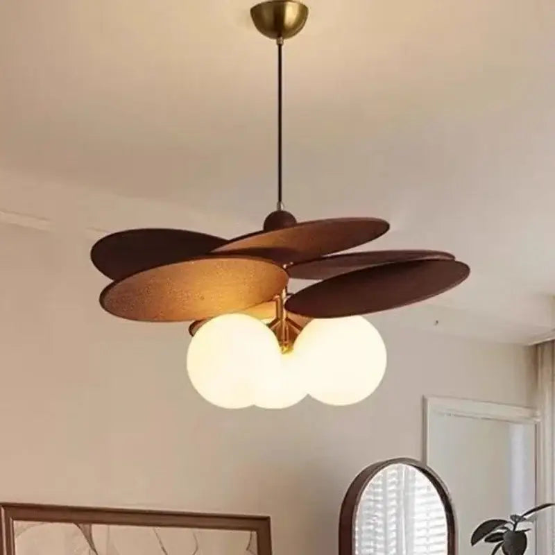 Vintage layered wood petal pendant light with warm-toned brass and frosted glass globes for dining room accents
