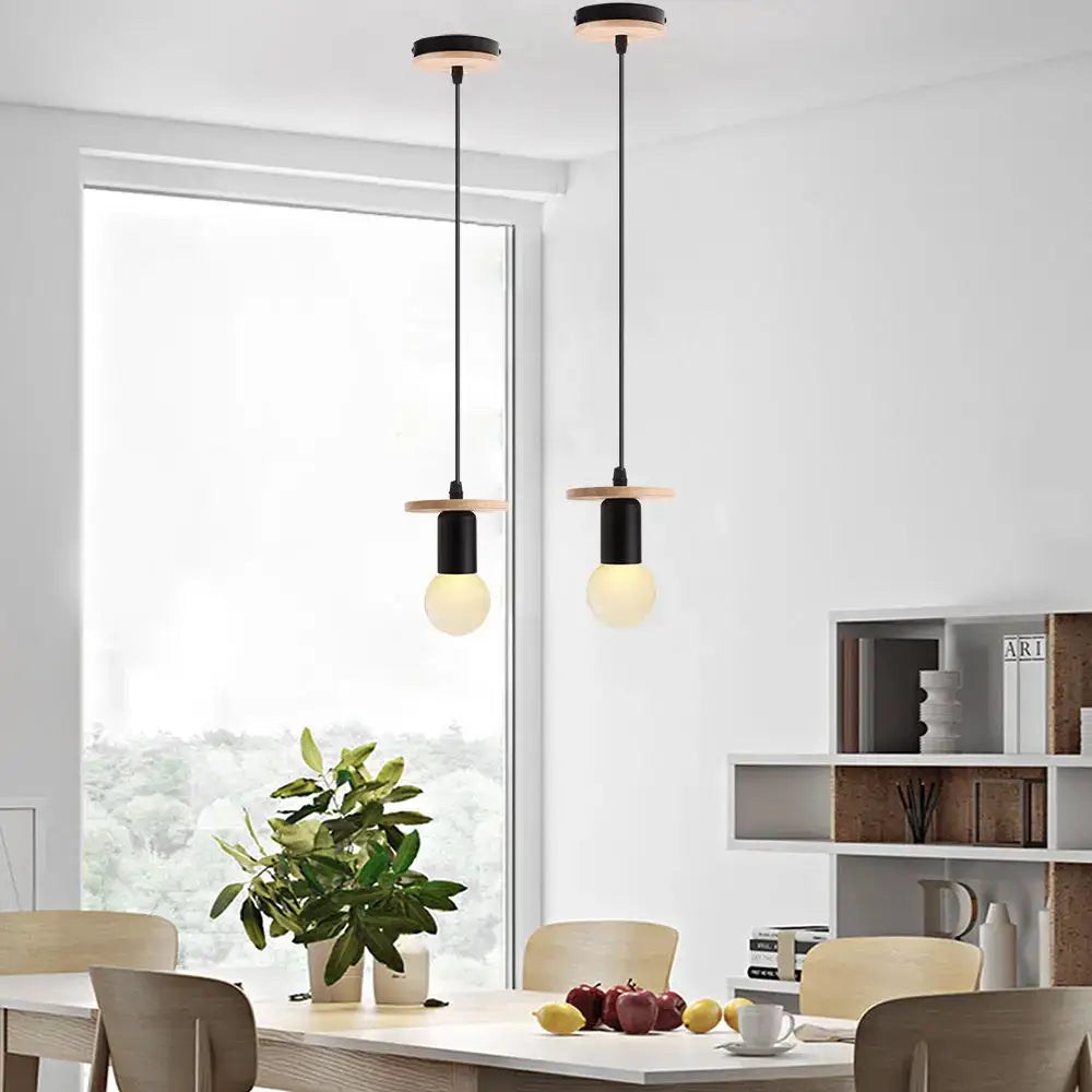 Two minimalist pendant lights with black cylindrical shades and light wood accents for led wood ceiling decorbites pendant light