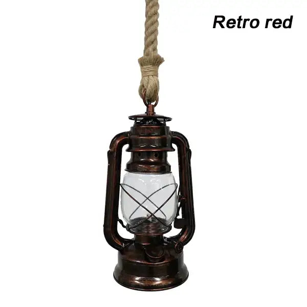 Vintage mixed metal cage pendant light with a red hanging lantern, copper metal construction, and clear glass globe for decorative presence